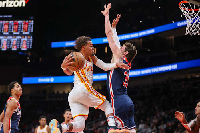 Atlanta Hawks guard Trae Young (11) passes the ball around Washington Wizards center Mike Muscala (35) in the second quarter at State Farm Arena.